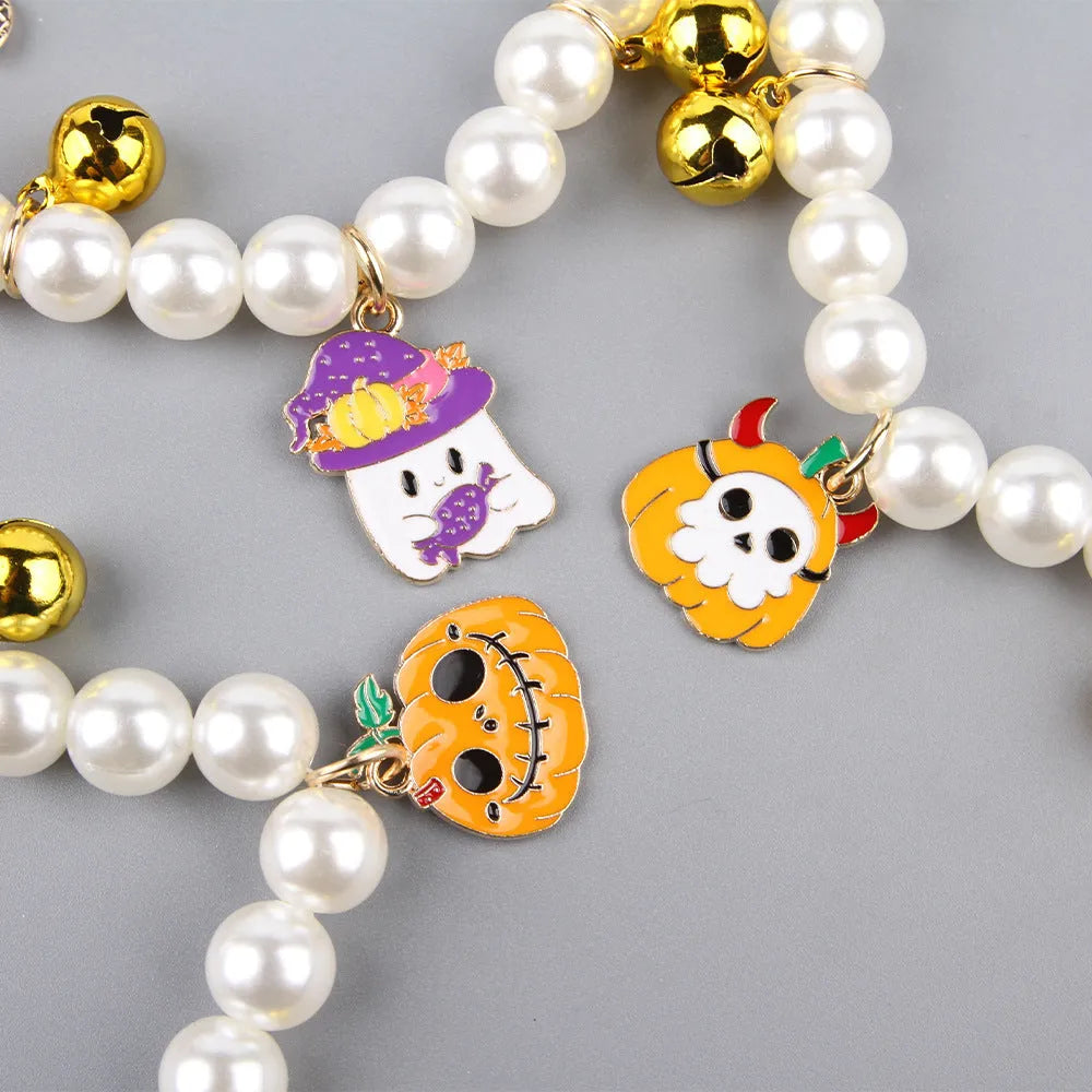 Halloween cat collar with simulated pearls and a choice of purple ghost, skull, or smiling pumpkin print.