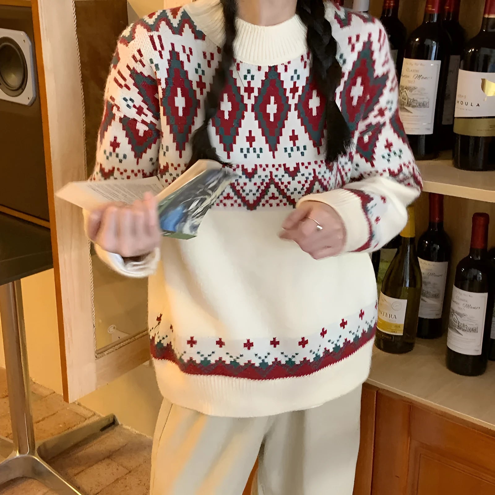 Loose red and white striped retro pullover knitted top with long sleeves on a hanger.