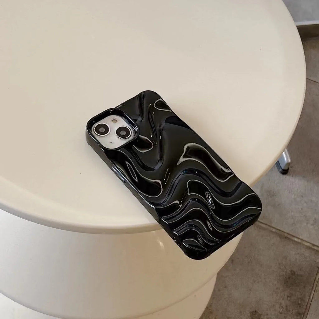 Three-dimensional pleated water ripple TPU phone case for iPhone 14 in glossy silver, showing textured back and edge coverage