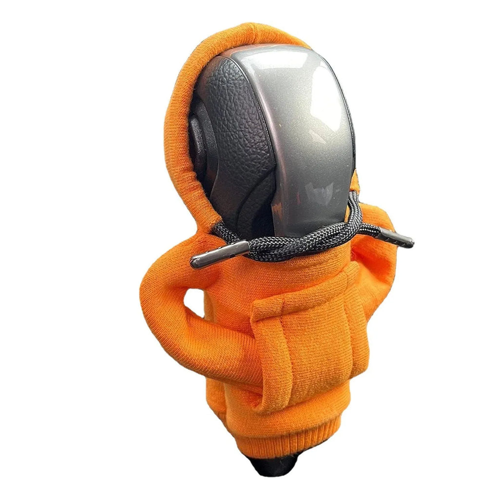 Blue cloth cover fitted over a car gear shift knob on a manual transmission.