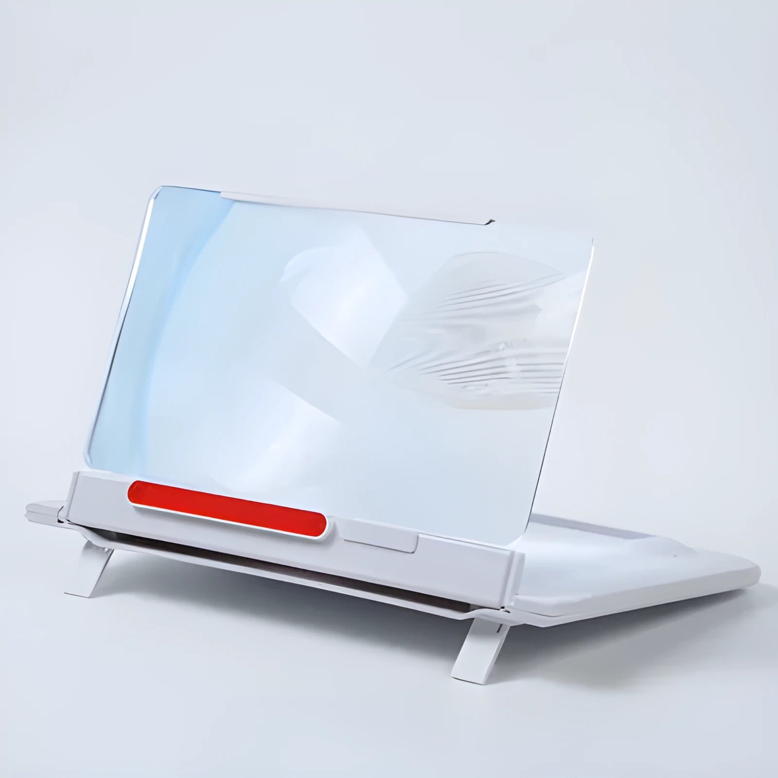 Black 12-inch mobile phone screen amplifier with pull-out stand on a table next to a phone.