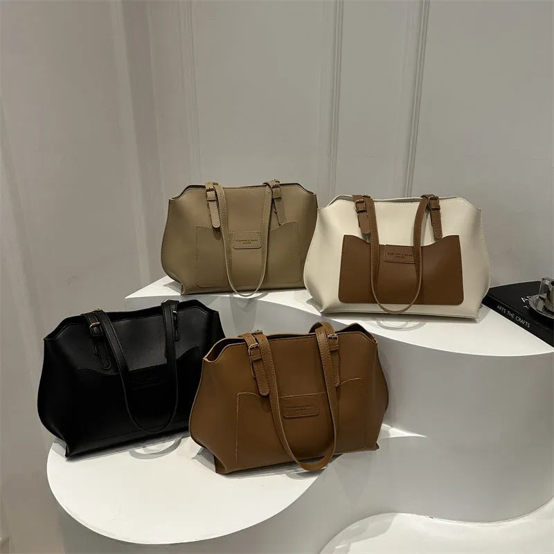 Women's square PU tote bag in black with double straps, showing external sandwich pocket and sewing line detail.