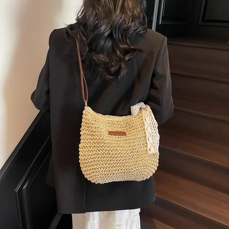 Women's woven straw messenger bag with hollowed pattern in khaki colour with zipper compartment