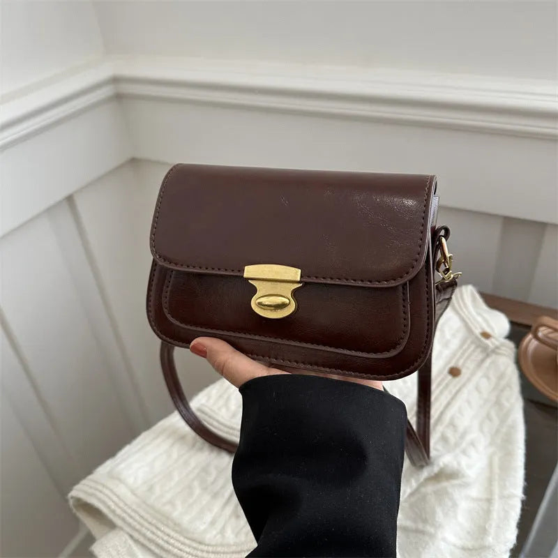 Retro-style small square handbag in soft brown PU leather with a horizontal silhouette.
