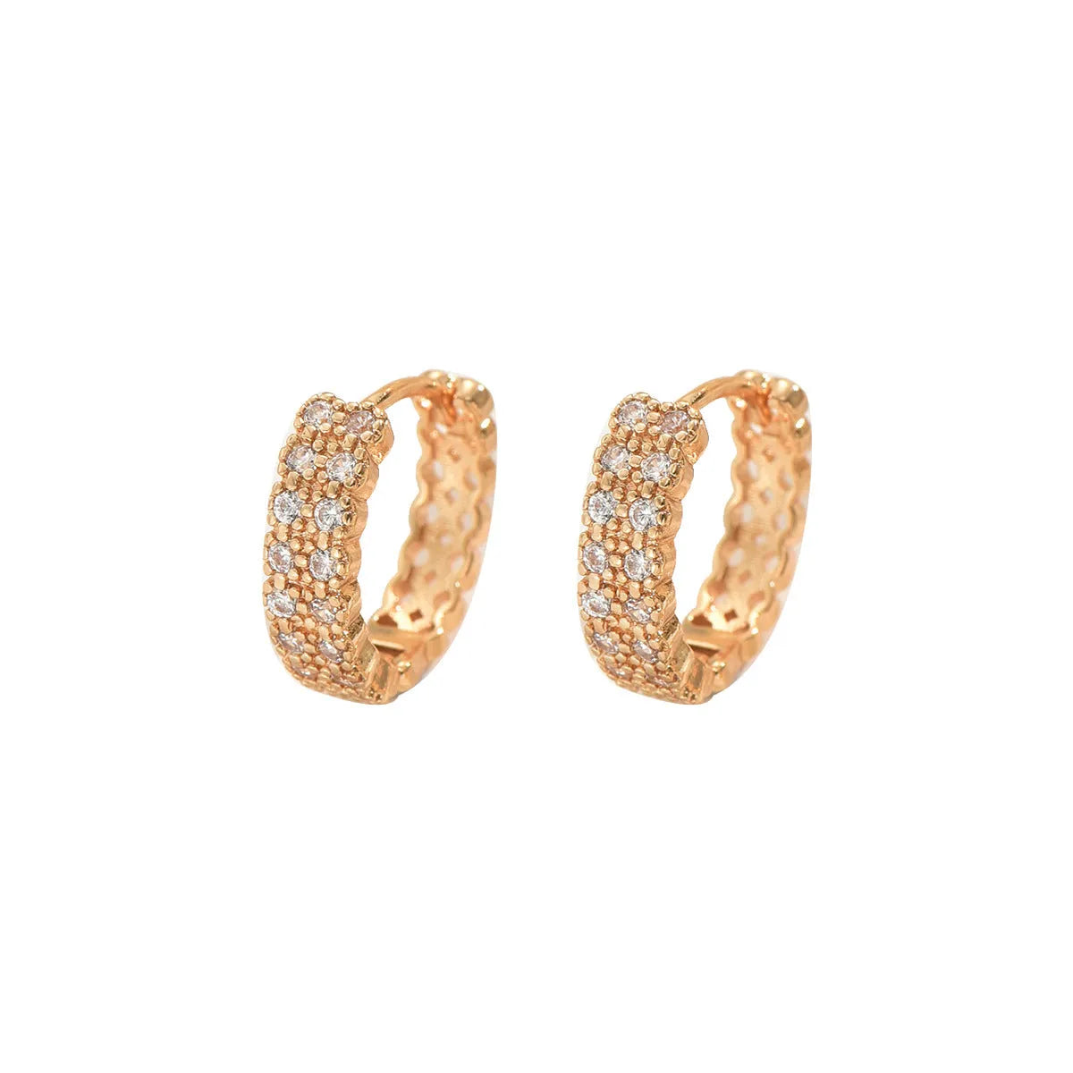 Polished copper geometry pattern ear studs with round base, central dot, and outer ring on a plain background.