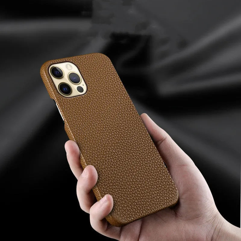 Genuine brown cowhide leather iPhone case with simple half line design on an iPhone 14 Pro Max.