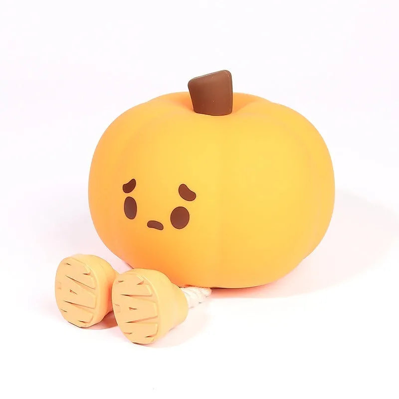 Orange silicone pumpkin-shaped night light with USB charging cable