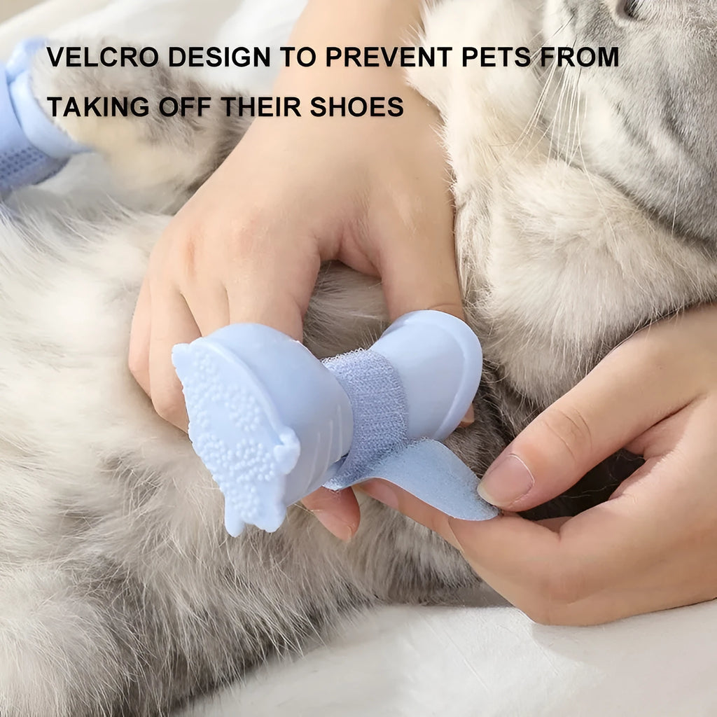 Set of four waterproof silicone dog rain boots in dark blue, gray, light blue, and pink on a white background