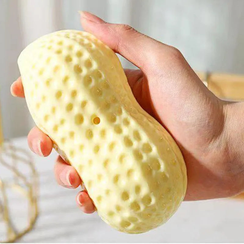 Yellow squeaky peanut-shaped dog chew toy made of durable TPR rubber.