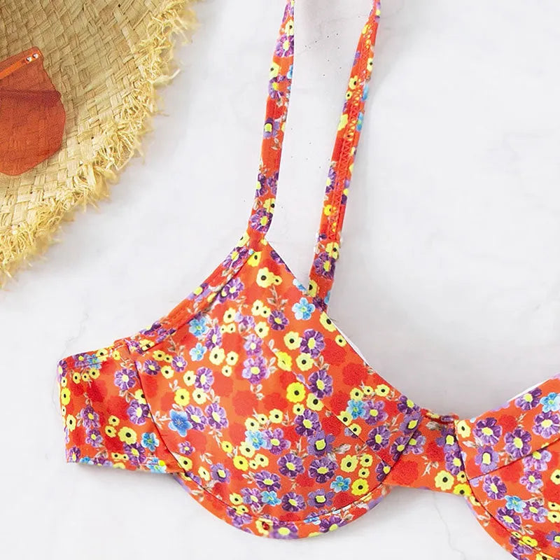 Red women's swimsuit with small floral pattern, high waist design, and side splits on legs