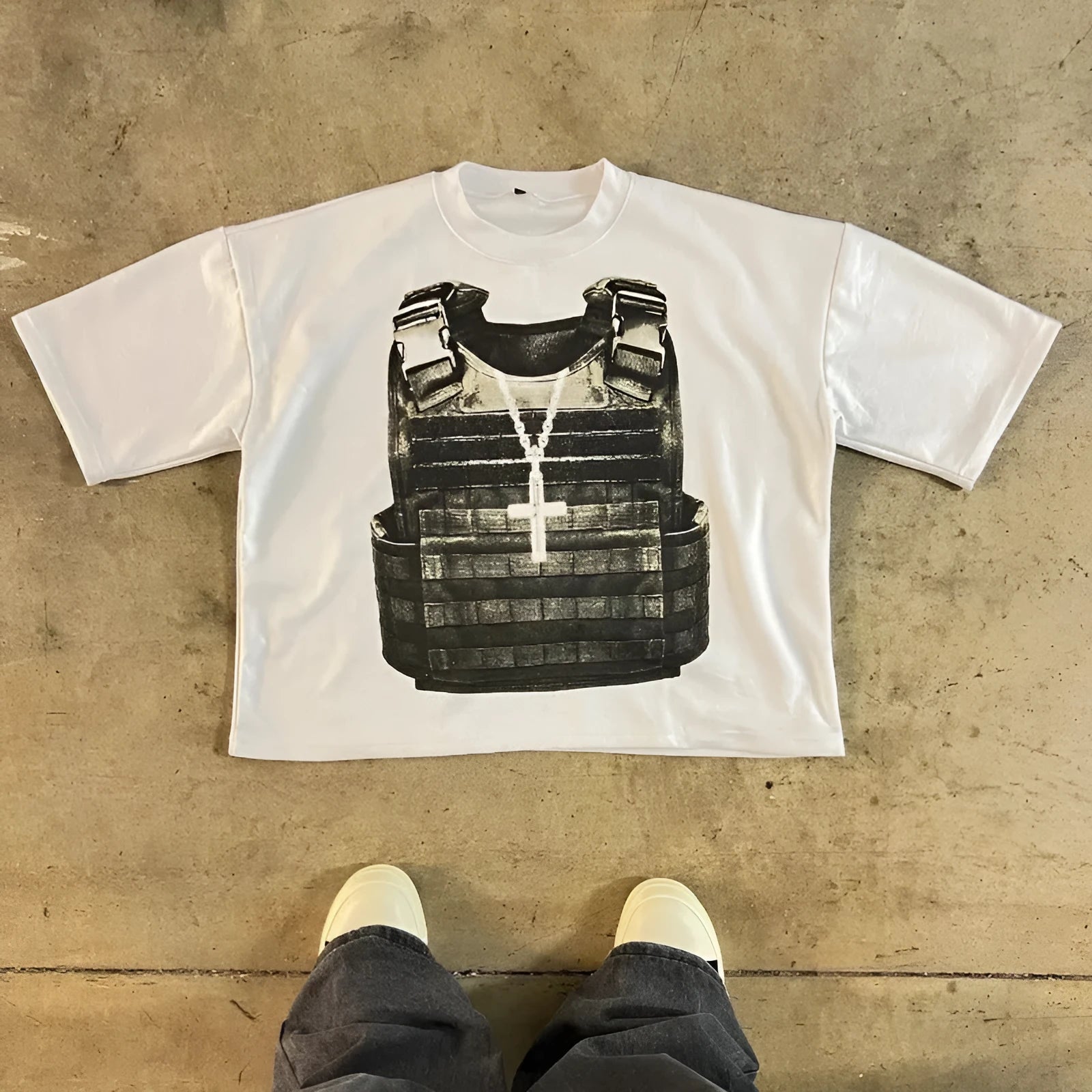 Person wearing a printed cotton short-sleeve pullover with a drop-shoulder design and retro graphic in a street hipster style.