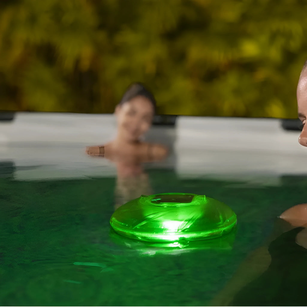 Bestway 58111 solar floating light floating on pool water surface with sunlight reflecting