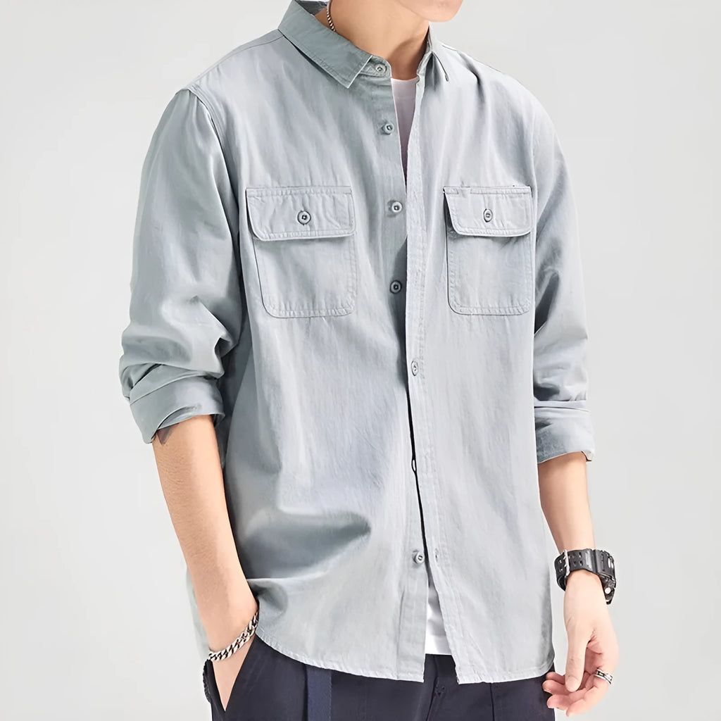 Man wearing a loose-fit light grey long sleeve cardigan-style shirt made from polyester.