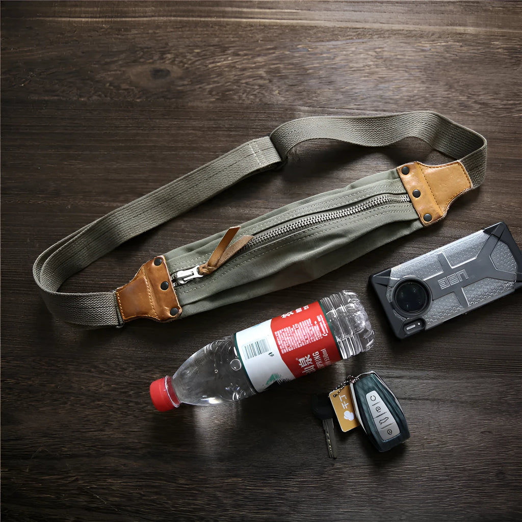 Green military style chest bag made from canvas with leather accents and adjustable shoulder straps