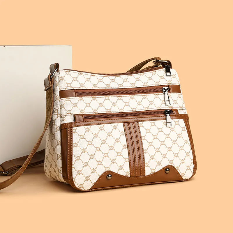 Women's brown and white stitching pattern large-capacity crossbody bag with PU exterior.
