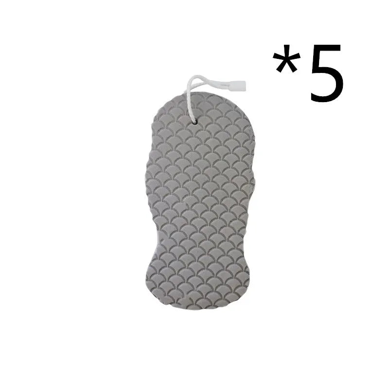 White 3D fish scale pattern bath sponge with hang loop on a bathroom background.