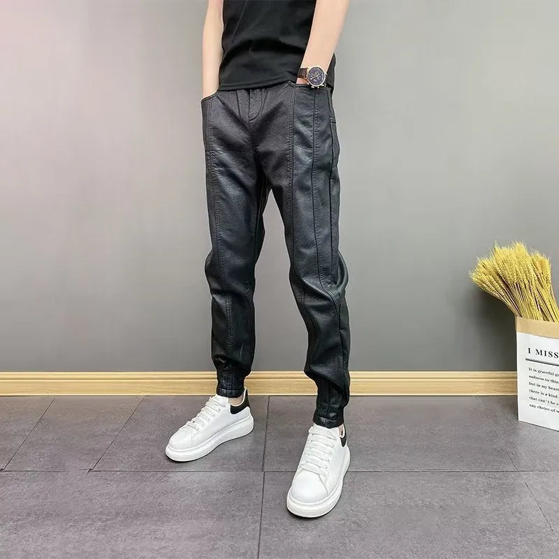 Black slim-fit waterproof motorcycle trousers in artificial leather with mid-rise waist and tapered leg
