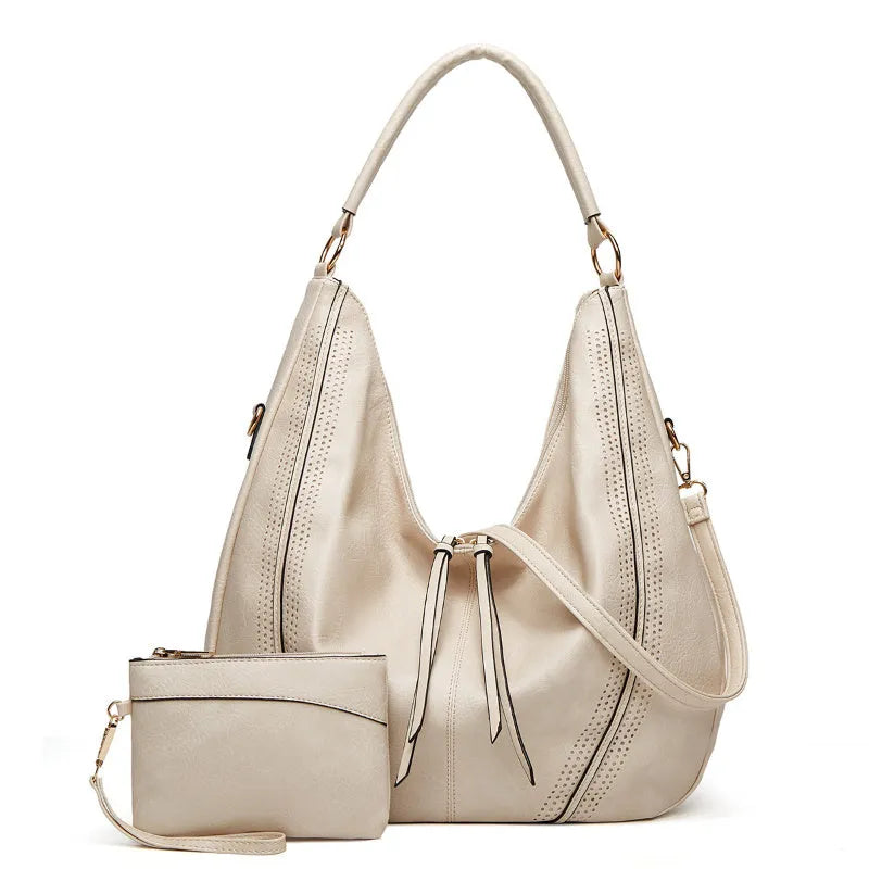 Retro large capacity PU tote shoulder bag with tassel hollow detailing and zipper closure in white