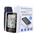 Automatic arm blood pressure monitor on a table with large screen and arm cuff.