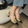 Women's black stiletto heel sandals with pointed toe, flower buckle, and shallow mouth opening.
