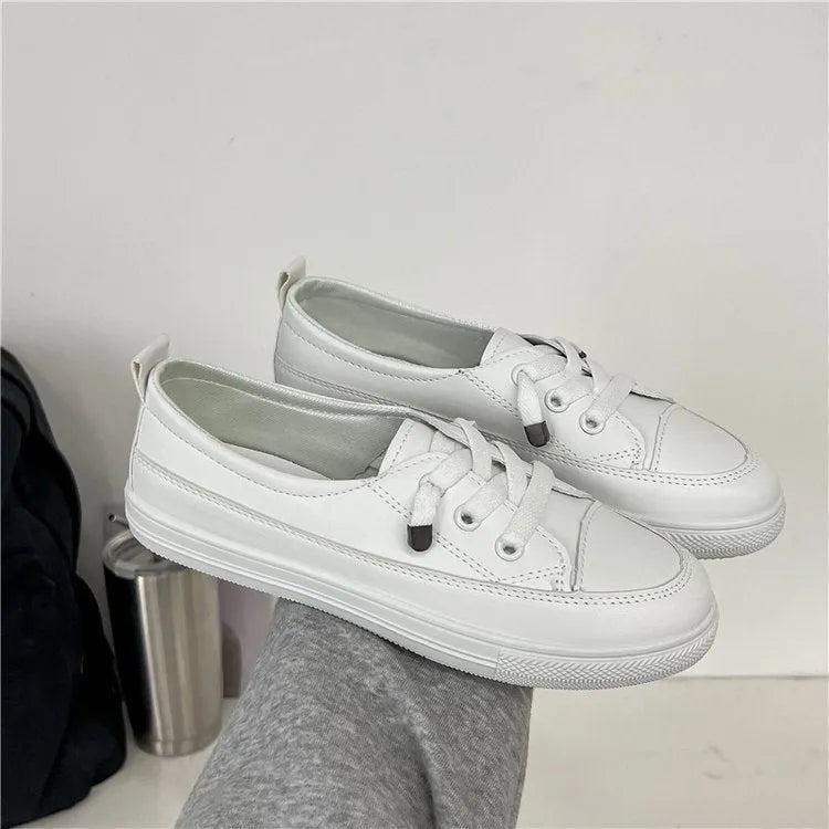 White women's sports breathable shoes with patent leather upper, flat heel, round toe, and front lace-up on a plain background