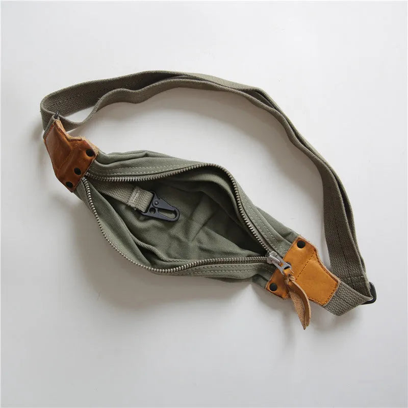 Green military style chest bag made from canvas with leather accents and adjustable shoulder straps