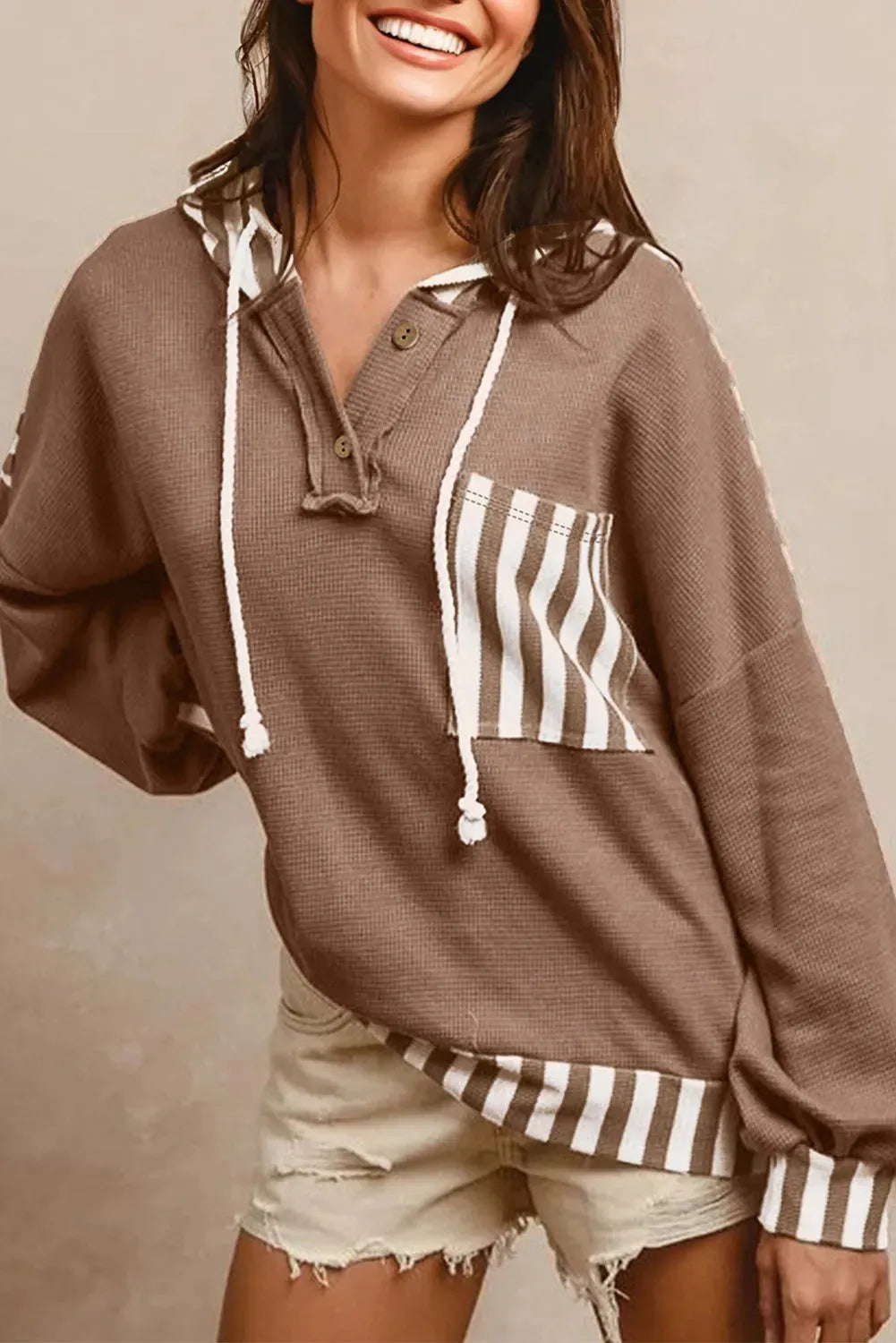 Straw yellow women's hoodie with waffle texture and striped patchwork design, featuring a button neck and drawstring waist.