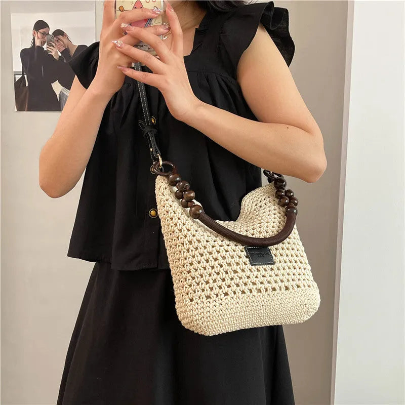 Knitted bucket tote beach bag in black or brown with contrast stitching and crossbody strap