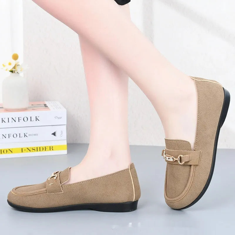 Women's black matte slip-on casual shoes with a round toe and soft rubber sole on a flat surface.