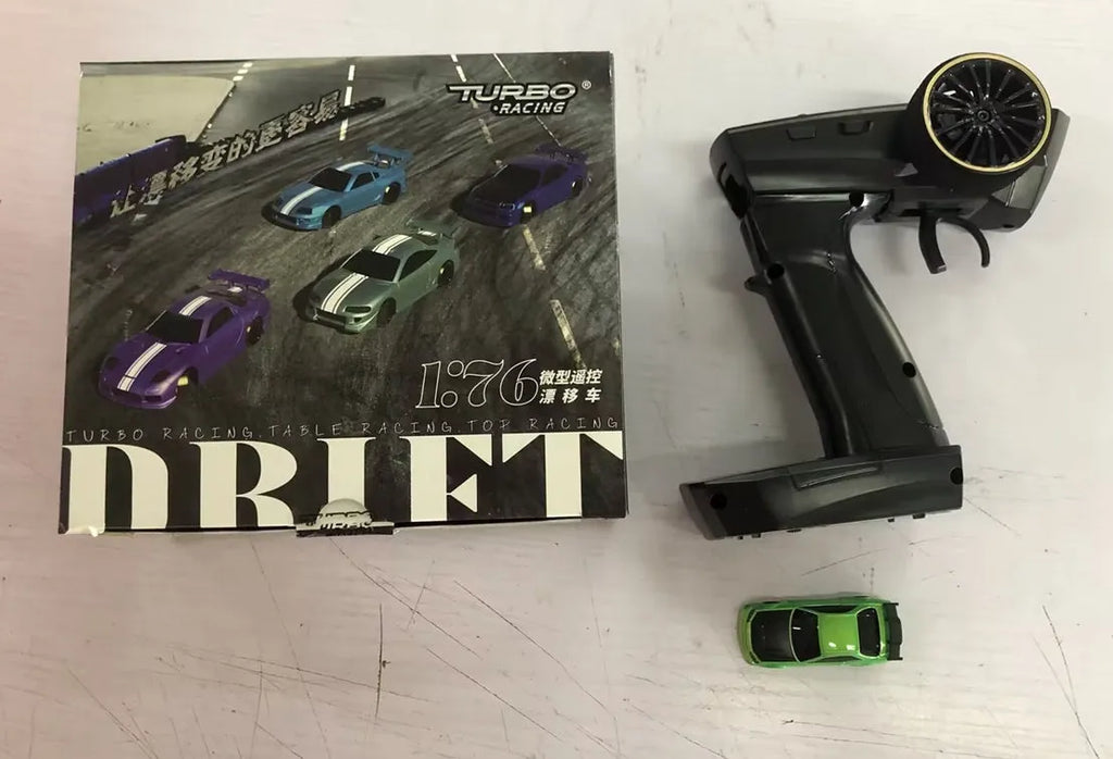 Blue Turbo Racing C64 gyro drift RC car with proportional remote control on a track