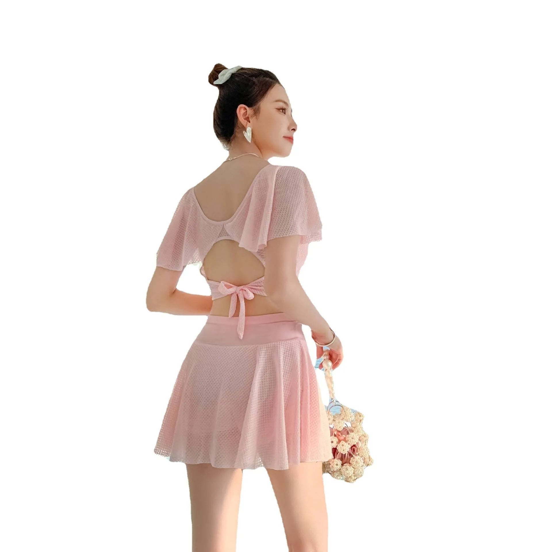 Women's solid colour two-piece swimsuit with a skirted bottom in white, black, or pink.