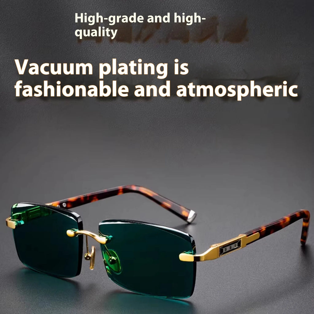 Frameless sunglasses with dark green tinted lenses and a black hard-shell case on a table.