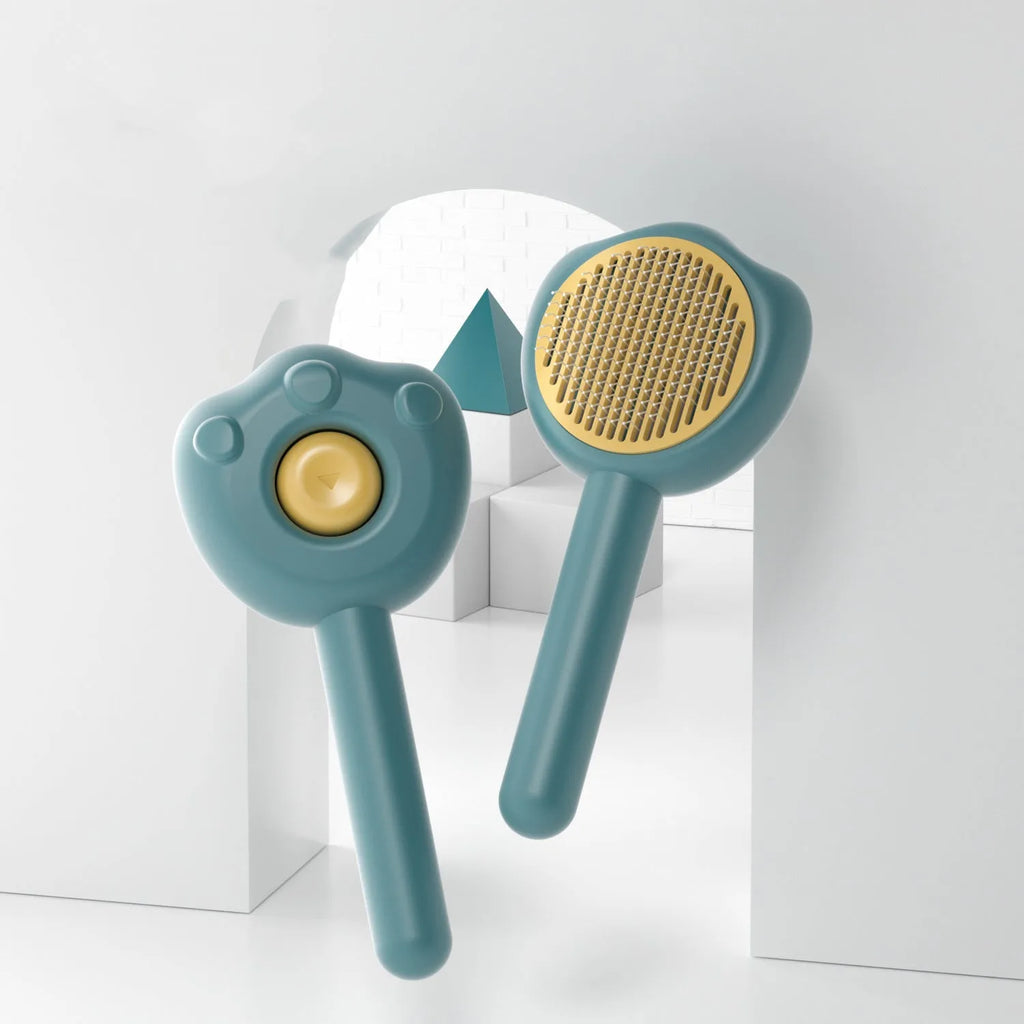 Blue self-cleaning pet grooming comb for cats with push-button mechanism and ergonomic handle