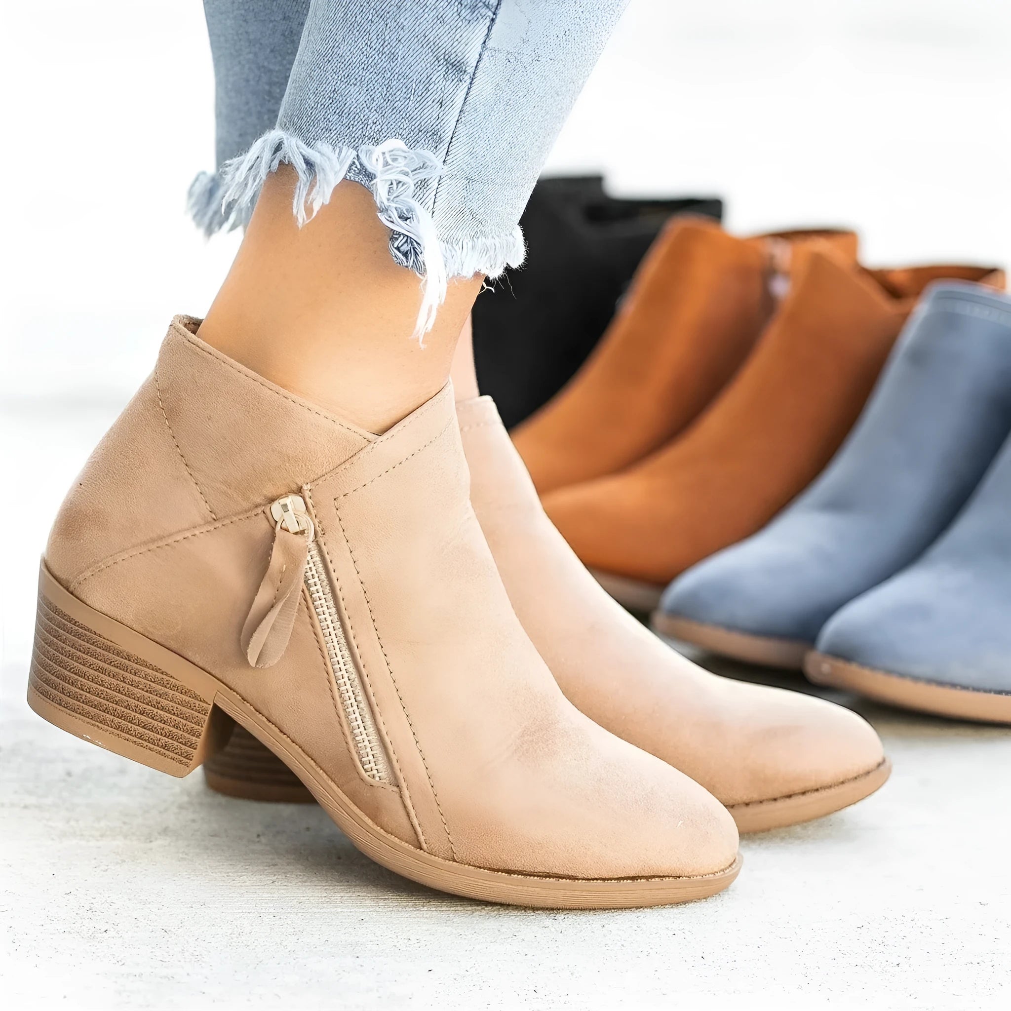 Women's blue suede ankle boots with side zip and chunky heel on white background