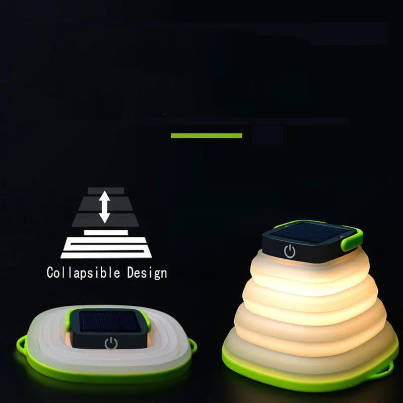 Green telescopic LED camping light folded and extended on a table with suction cup