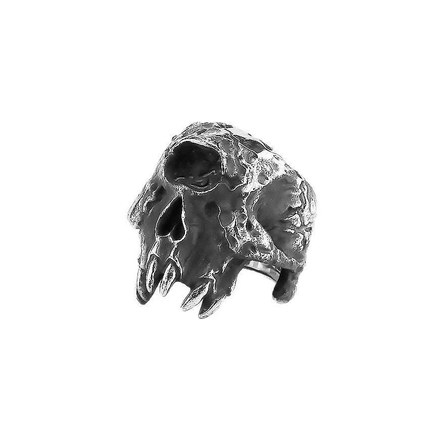 Alloy one-eyed skull ring in a retro electroplated finish, shown on a finger.