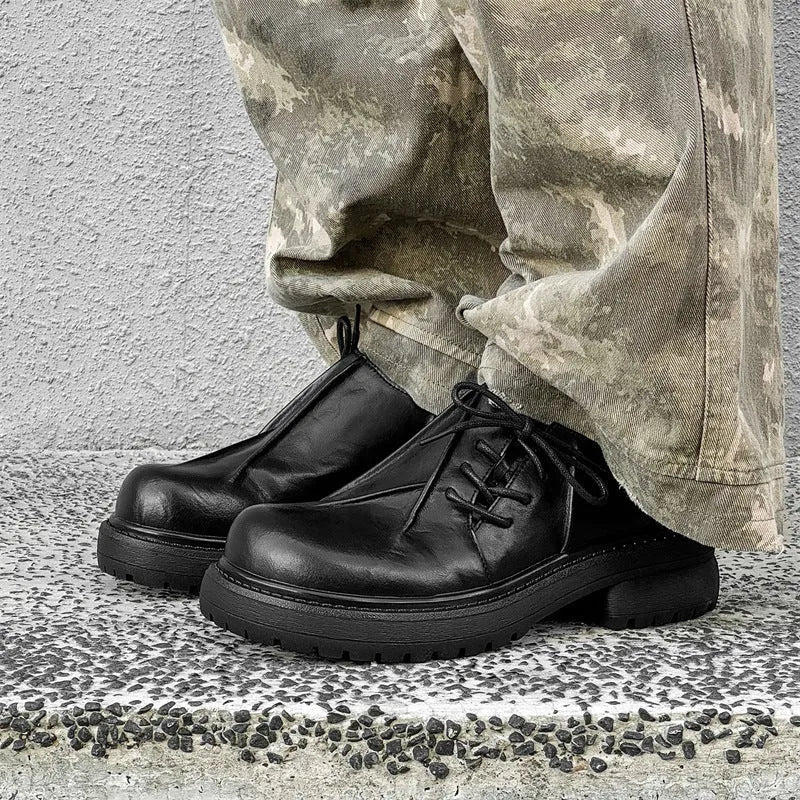 Black low-top platform leather shoes with round toe and rubber sole