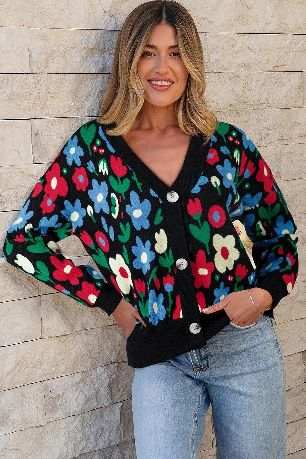 Black floral print V-neck button cardigan sweater with long sleeves and colour-block detail, laid flat