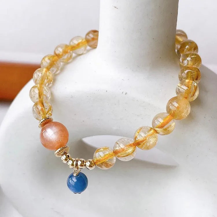 Gold rutilated quartz and sunstone crystal bracelet with diamond beads on adjustable band