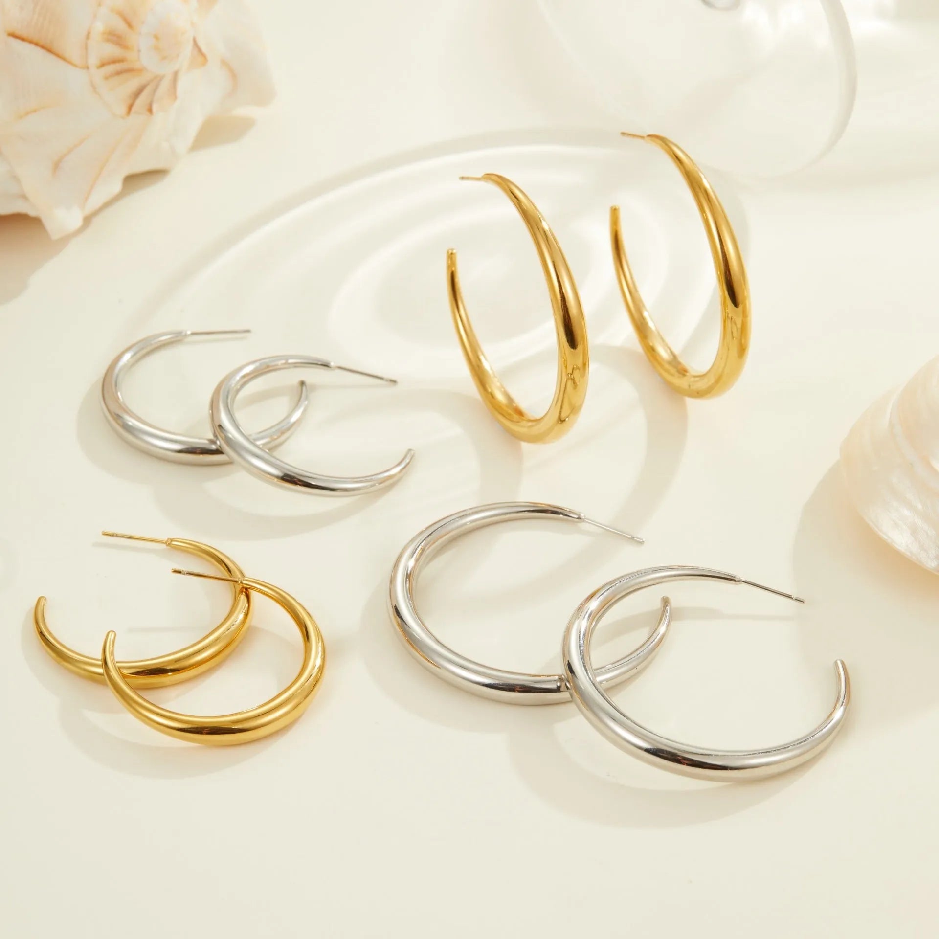 Titanium steel hoop earrings with 18K gold plating in geometric round design