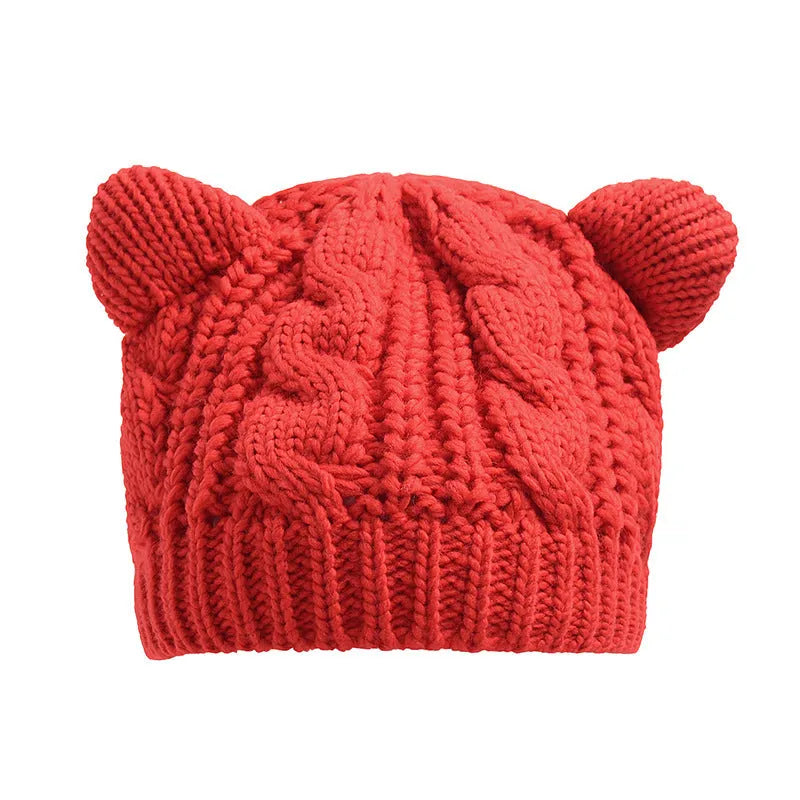 Hand knitted winter beanie with 3D cat ears in soft wool, shown in multiple colours.