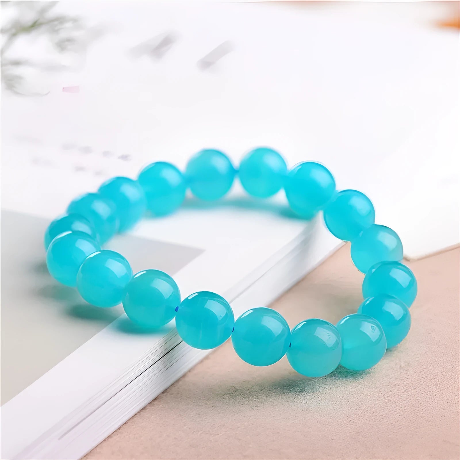 Polished natural Amazonite scattered beads in blue-green tones, shown loose and on a bracelet cord.