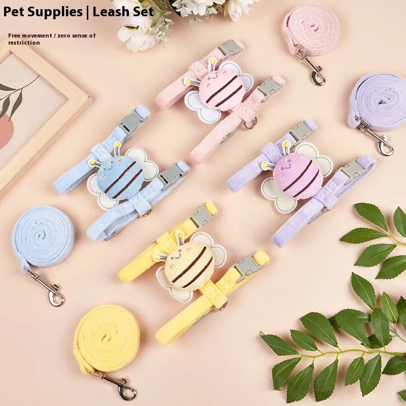 Pink, yellow, and blue bee-shaped adjustable cat leash with strap and hand rope on grass.