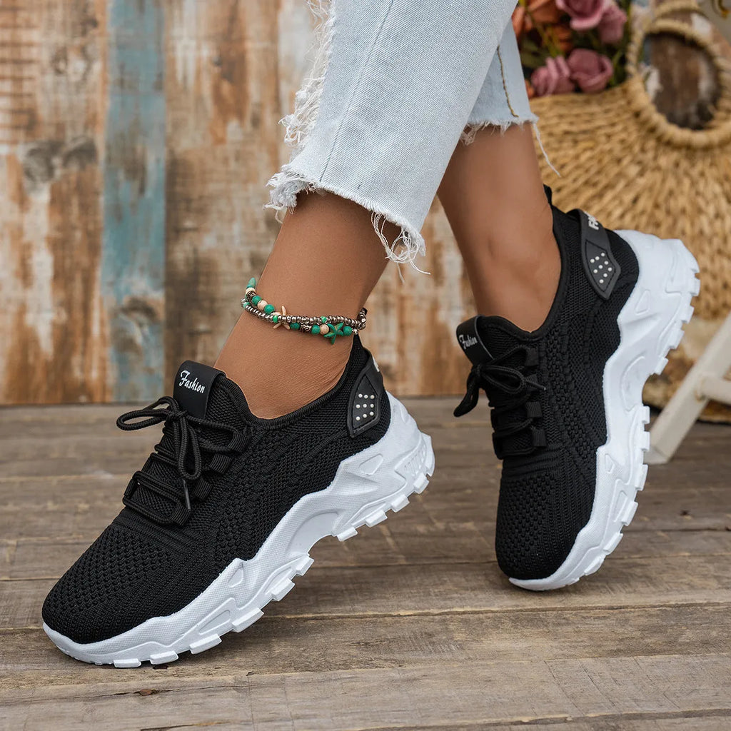 Women's Flyknit mesh casual trainer in multiple colours on a white background, showing lace-up front and round toe design