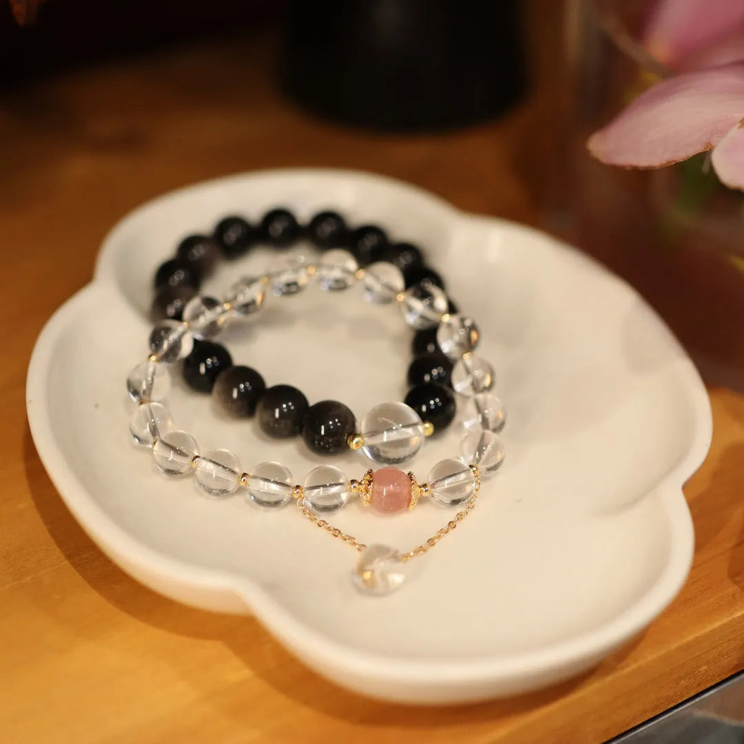 White and pink crystal bracelet with geometric Chinese design and cat eye obsidian elements