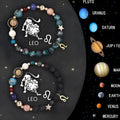 Two adjustable natural stone beaded bracelets on a table, showcasing the sliding knot and zodiac charm details.