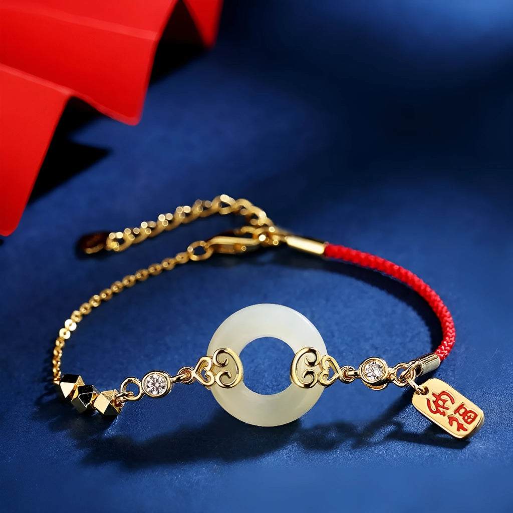 Women's Chinese style Hetian jade and sterling silver jewellery set showing bracelet, necklace, and earrings.