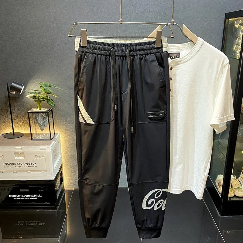 Man wearing black ultra-thin ice silk cropped trousers with a banded ankle cuff.