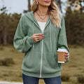 Forest green women's loose-fit hooded zip-up sweater coat on a hanger, showing front zip and long sleeves.
