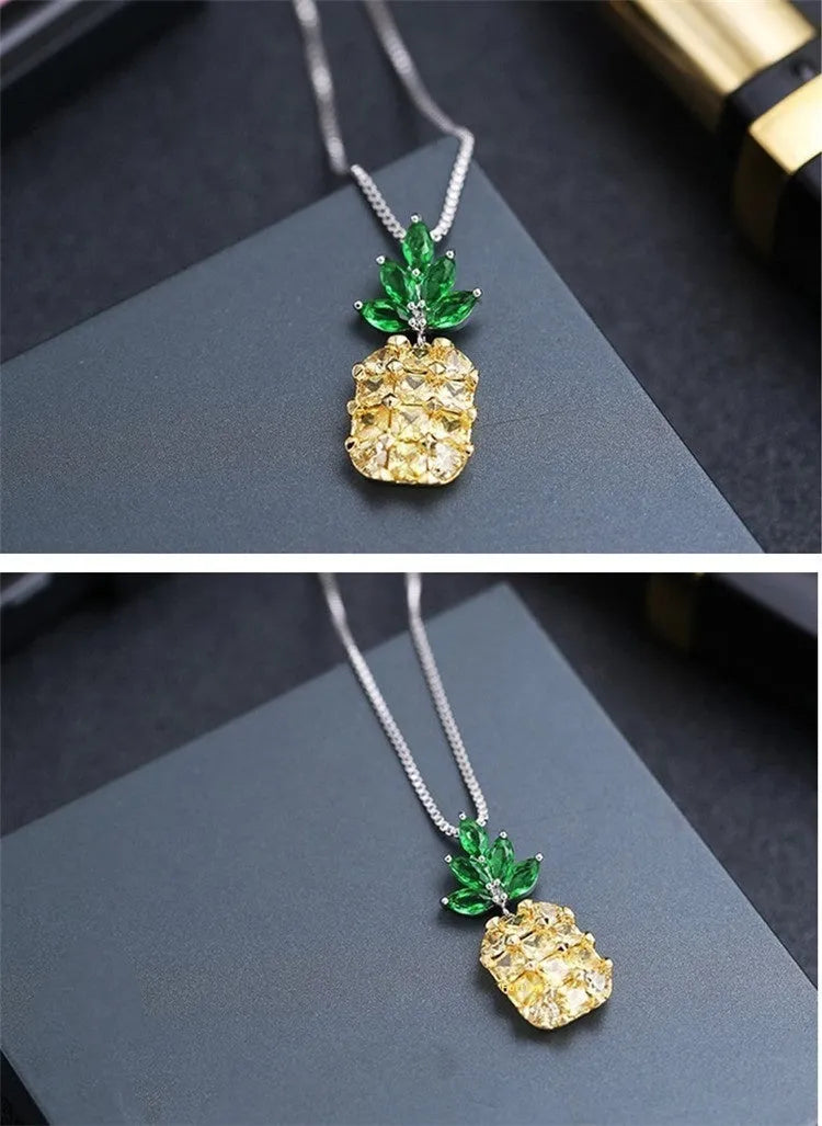 Women's silver tone necklace with a geometric pineapple and diamond motif pendant on a chain.